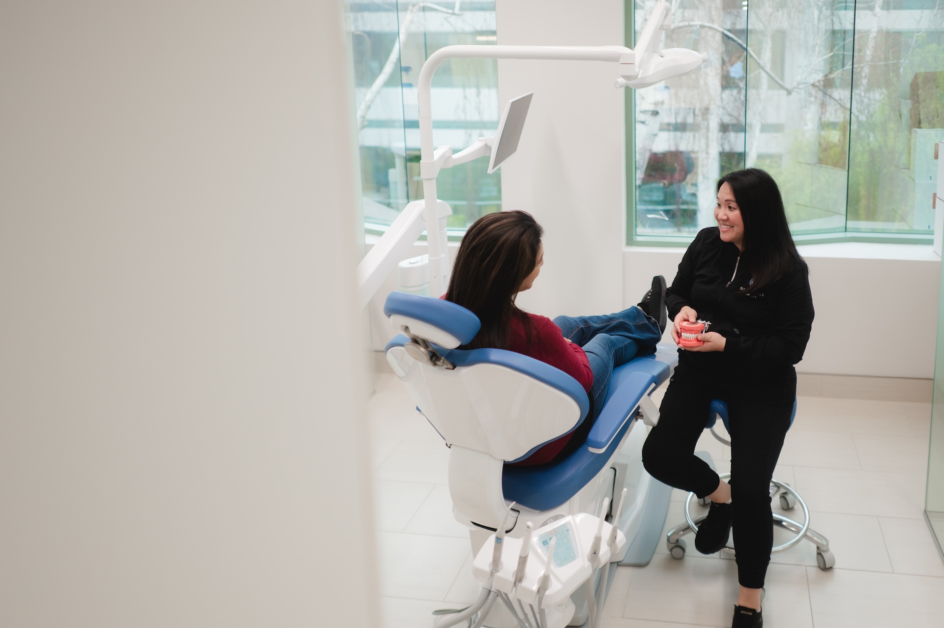 Our experienced Dr. at Sustainable Smiles explaining natural-looking teeth fillings to a patient