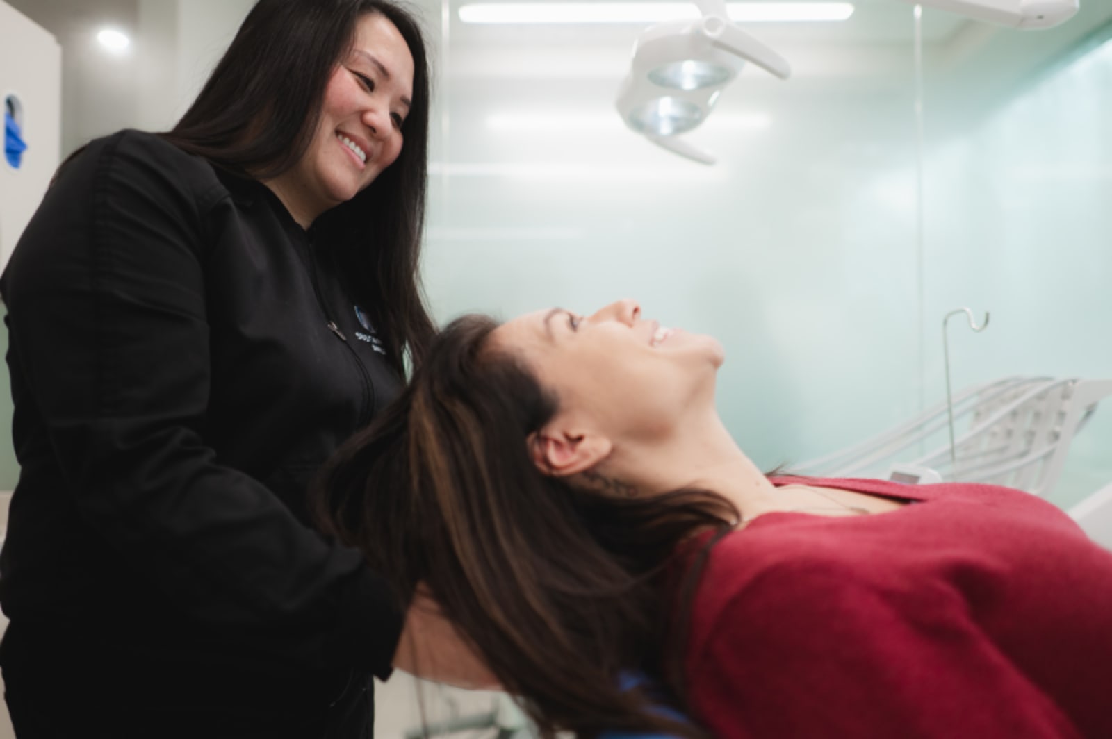 Dentist performing an oral examination on an adult patient