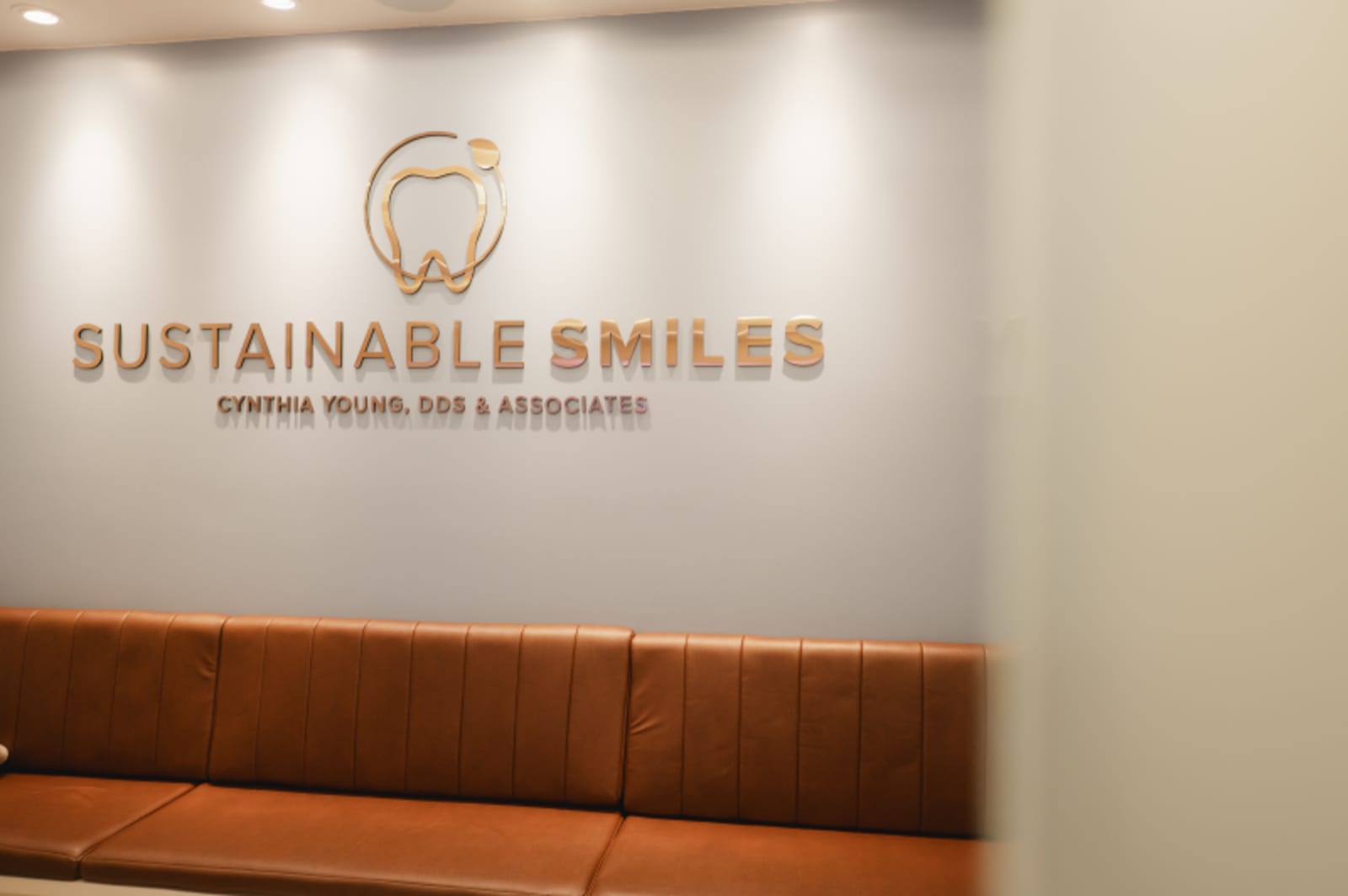 Sustainable Smiles dental practice logo and branding on reception wall