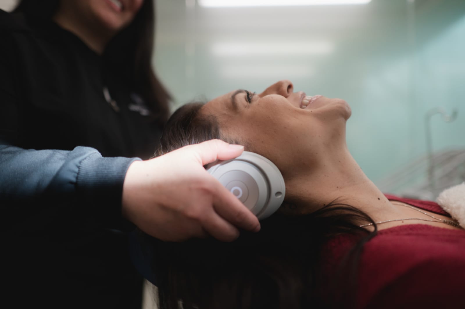 Dentist explaining treatment to young patient in modern operatory
