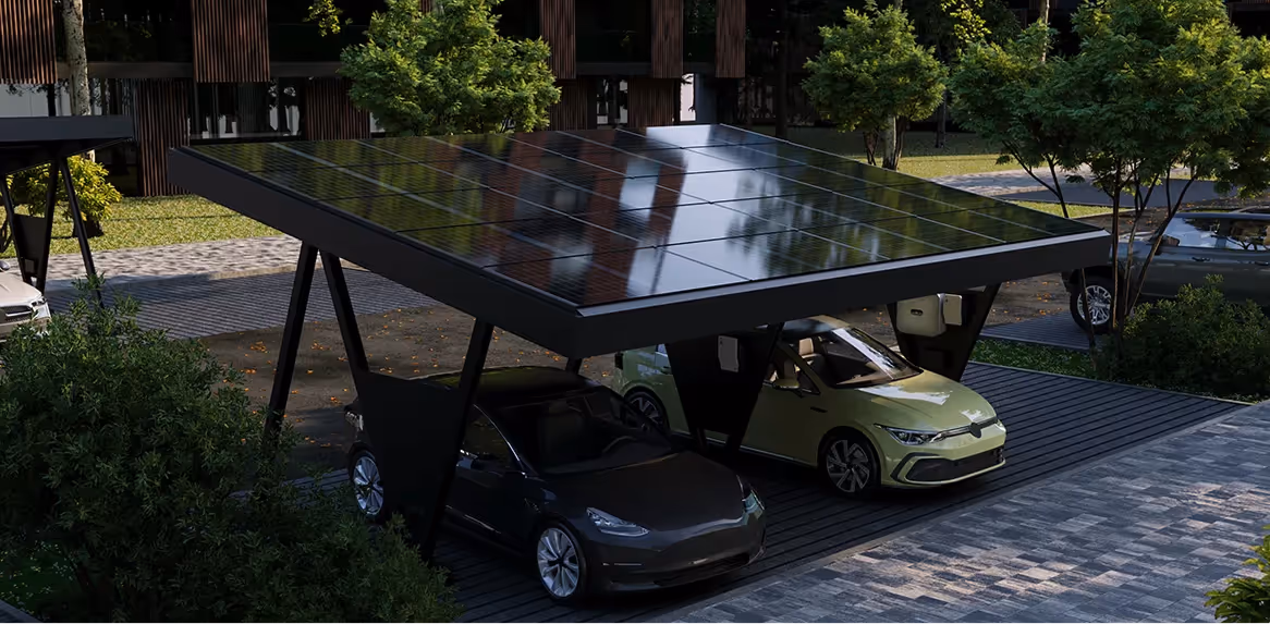 Two electric cars parked under a solar panel carport in a landscaped urban area.