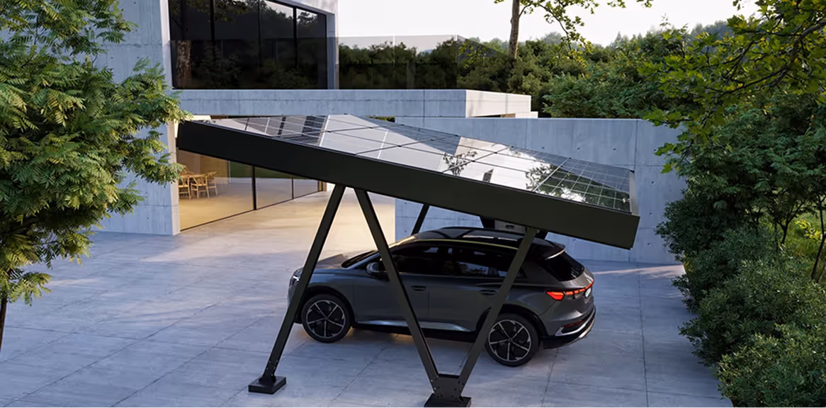Modern house driveway with a gray SUV parked under a solar panel carport supported by angled legs.