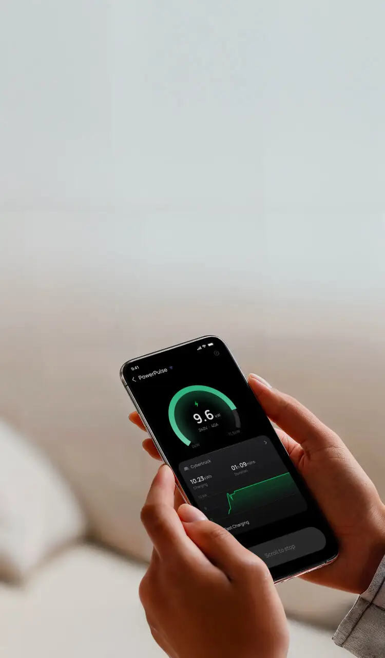 Person holding phone with app showing 9.6 kW power charging data and charging duration.