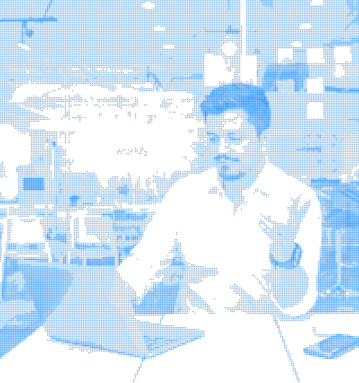 Man sitting at a desk working on a laptop in a modern office environment.