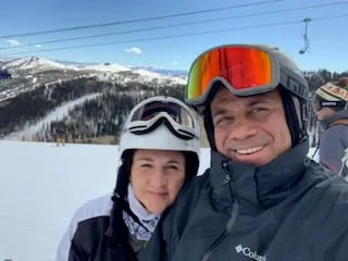 David, smiling, outdoors at a ski resort