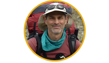 Van, smiling, outdoors wearing a hat and backpack