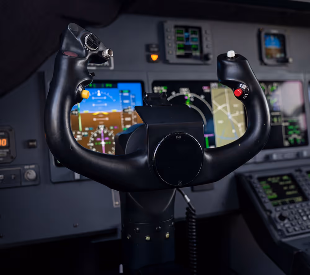 Close-up of the cockpit in private jet with screens and instruments in the background.