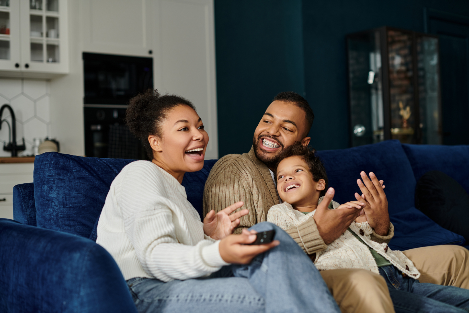 Family sitting on couch smiling stock image