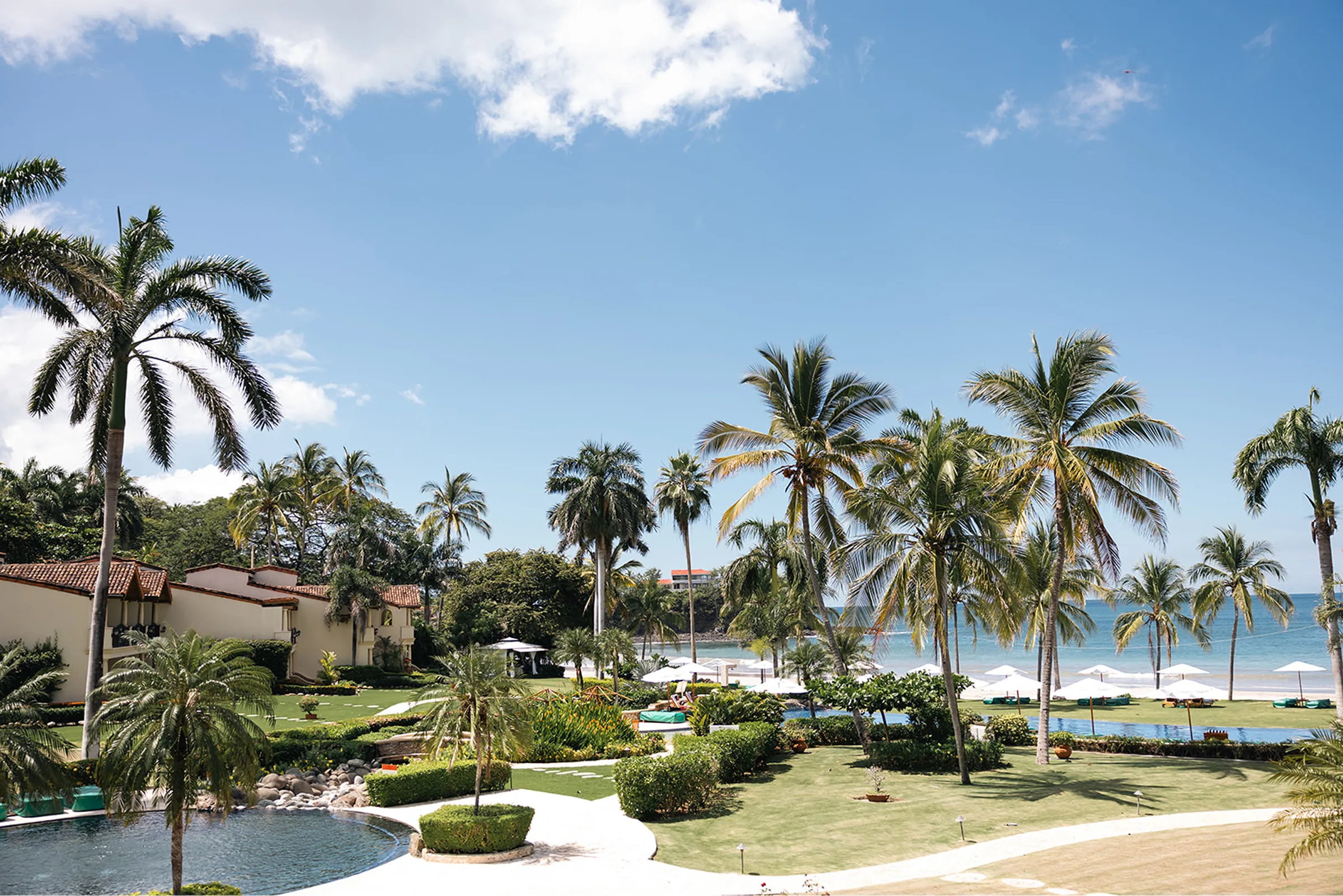 Palm-lined resort grounds and beach at Ralia's oceanfront retreat in Guanacaste, Costa Rica