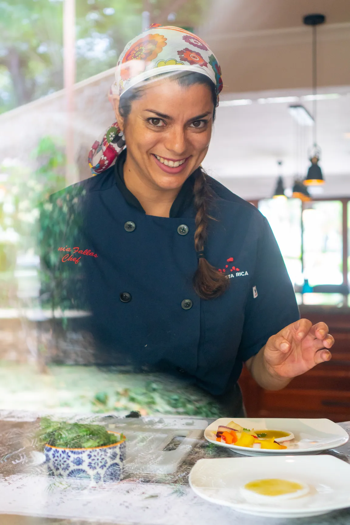 Chef Dania Fallas presenting plated dishes at Ralia's Costa Rica retreat