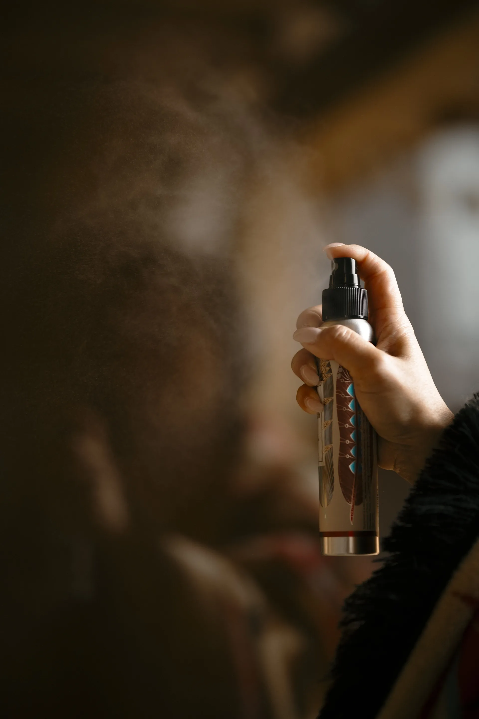 A guest spraying a wellness mist during a self-care ritual at La Maison Ralia in Montreal