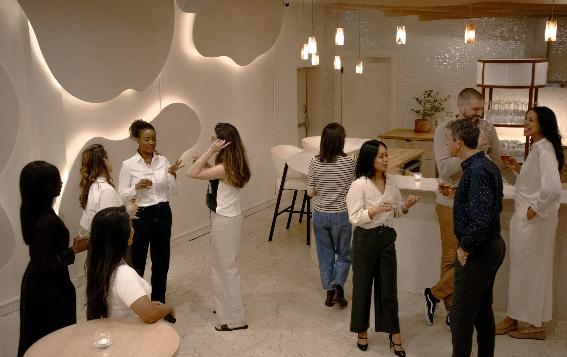 Guests mingling by the bar during a reception in the Connections event space at La Maison Ralia Montreal