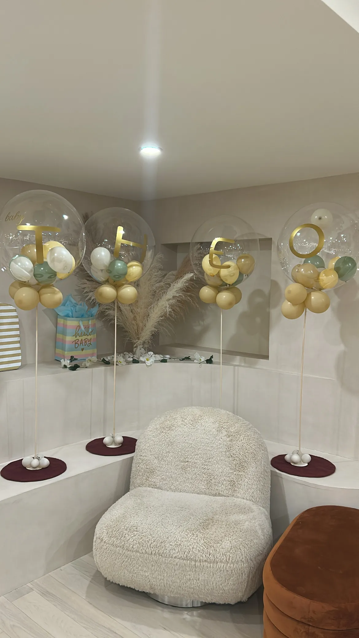 Baby shower setup with pastel balloon displays and pampas grass in the curved white lounge at La Maison Ralia