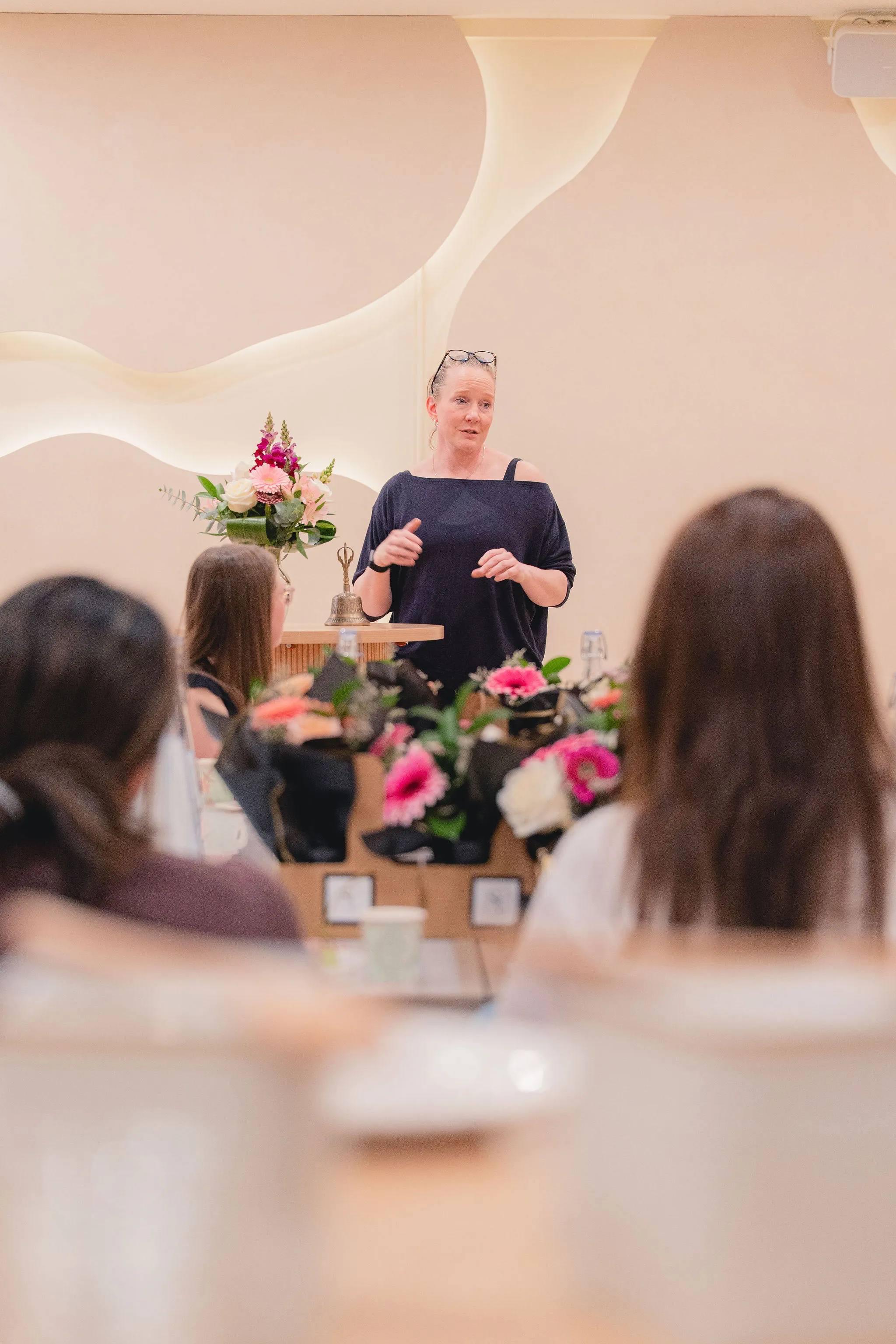 Speaker leading a floral workshop for seated guests in the Connections event space at La Maison Ralia Montreal