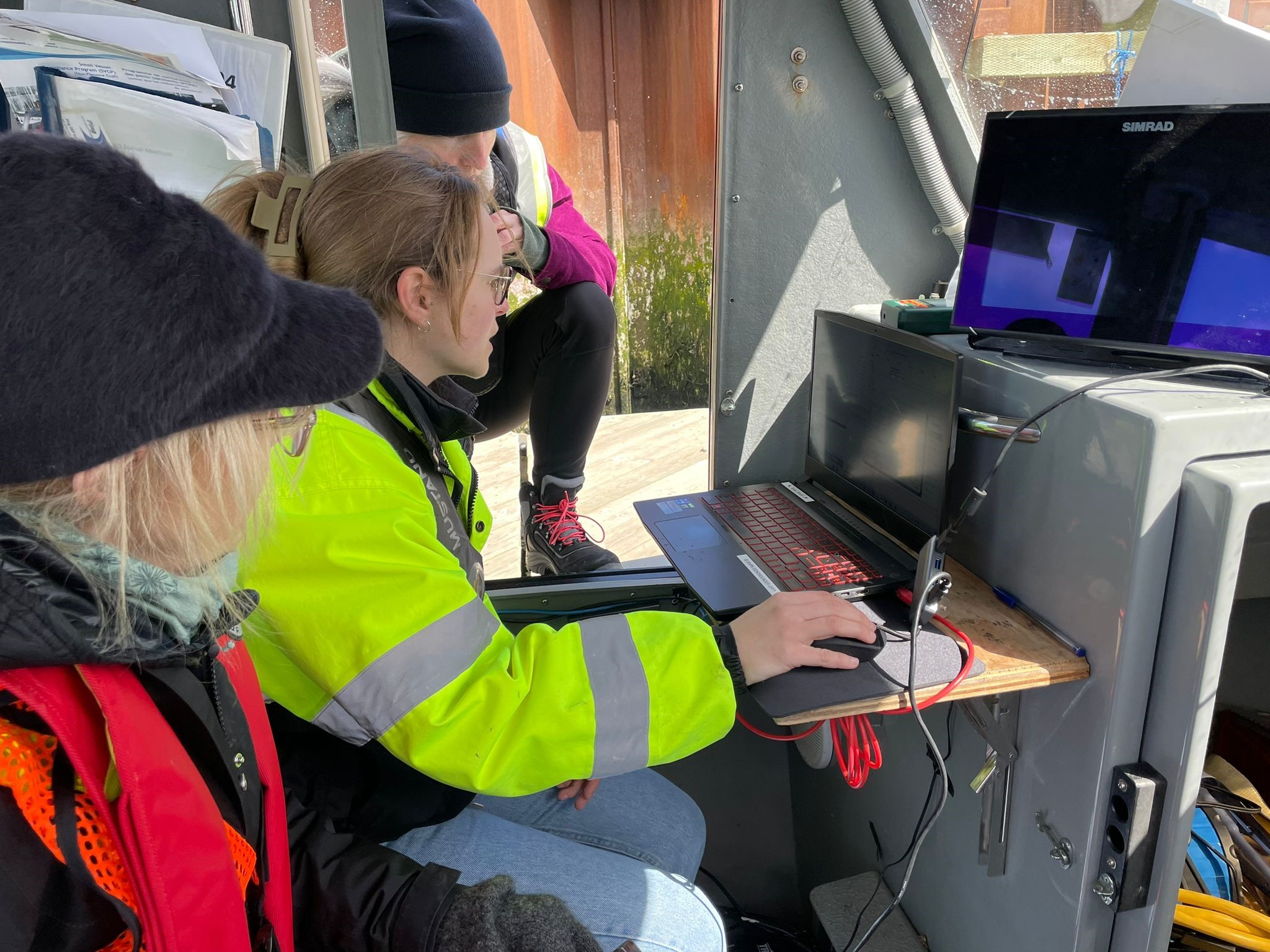 Surveyors performing system checks on a survey vessel