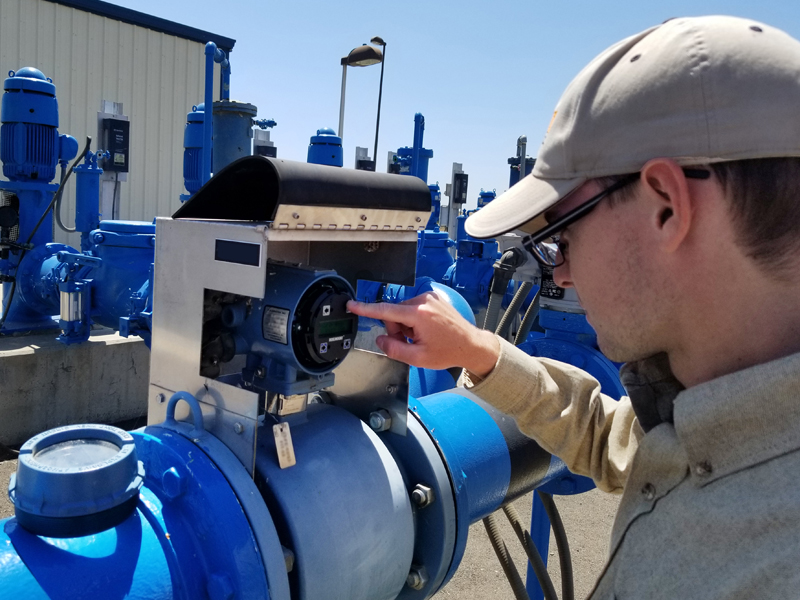 EMASS technician calibrates an instrument at a water treatment plant.