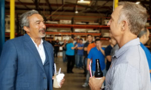 Rep Bera with ice cream float talking with staff