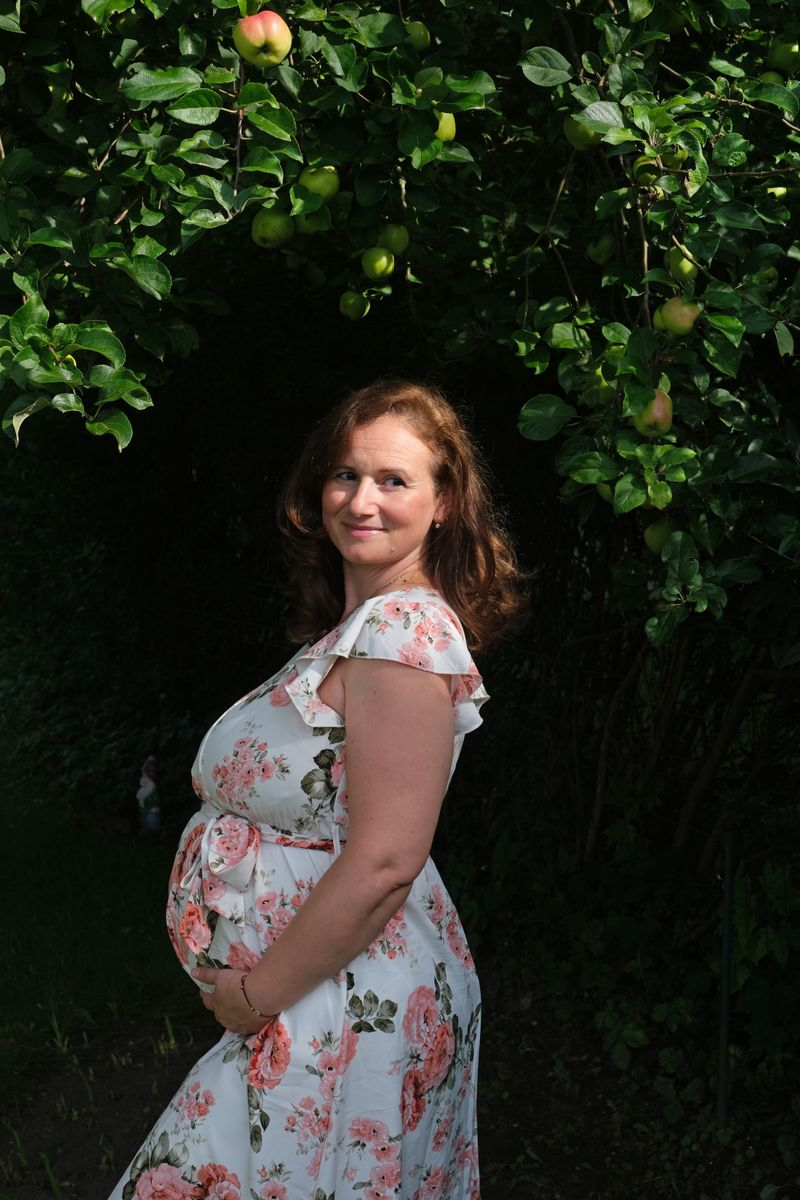 Diana Z. Petrova during pregnancy beneath an apple tree