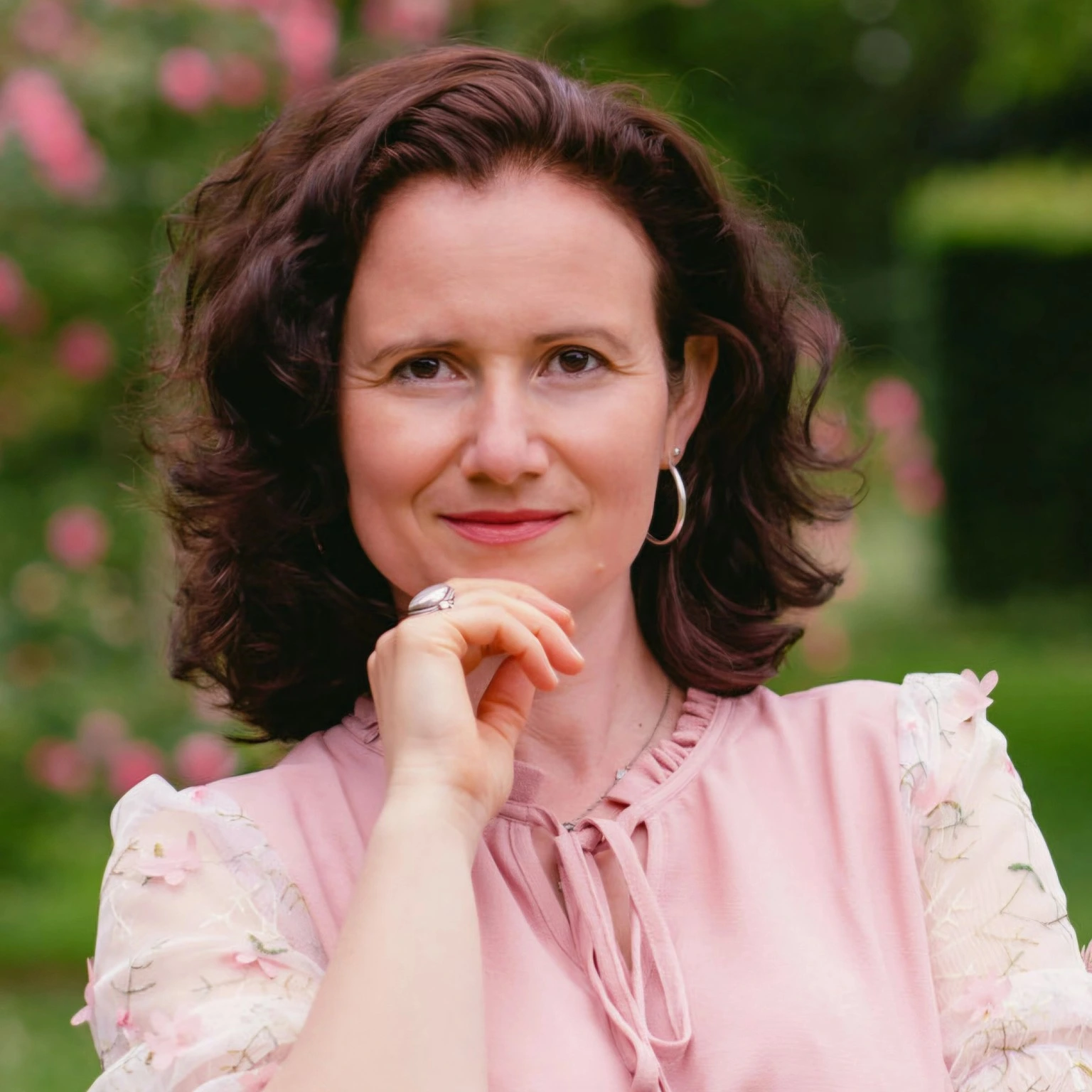 Diana Z. Petrova, founder of Womb Visions, in a pink blouse.