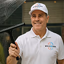 MyCleanWindow technician smiling in branded white polo and cap