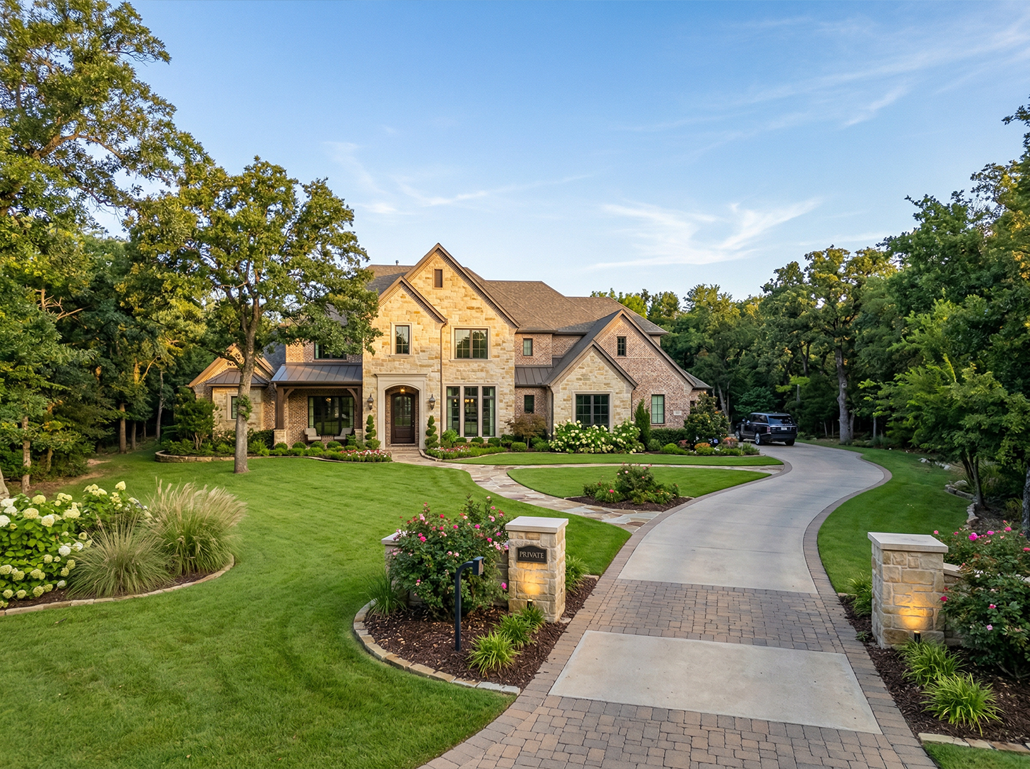 Custom estate home with stone exterior and large windows in Colleyville, Texas