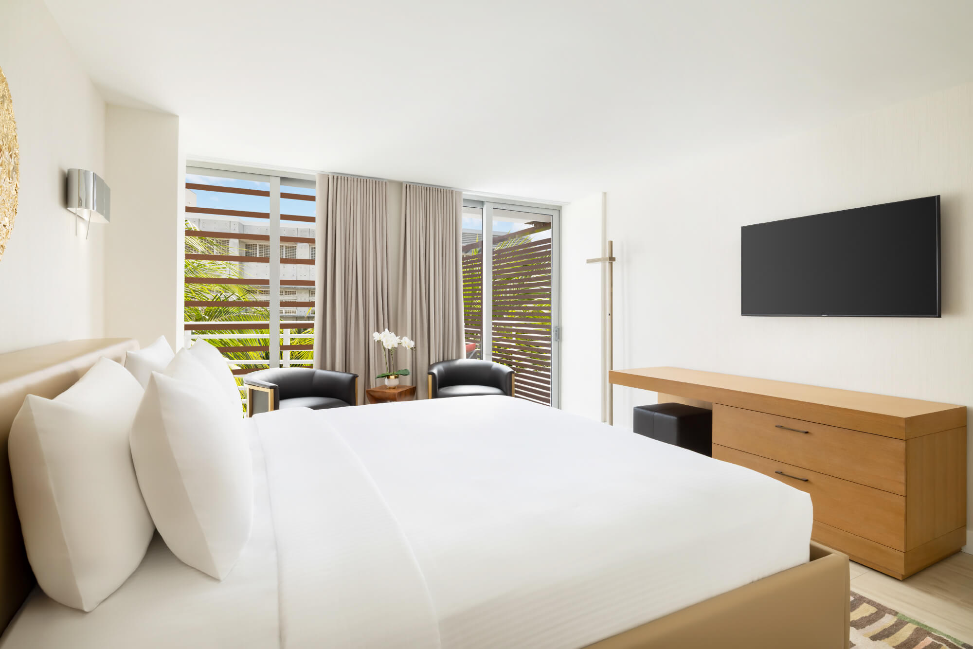 An intimate 300-square-foot escape for two featuring a plush king bed and a private terrace. Includes a mini fridge, 55\" TV, and coastal-inspired design.