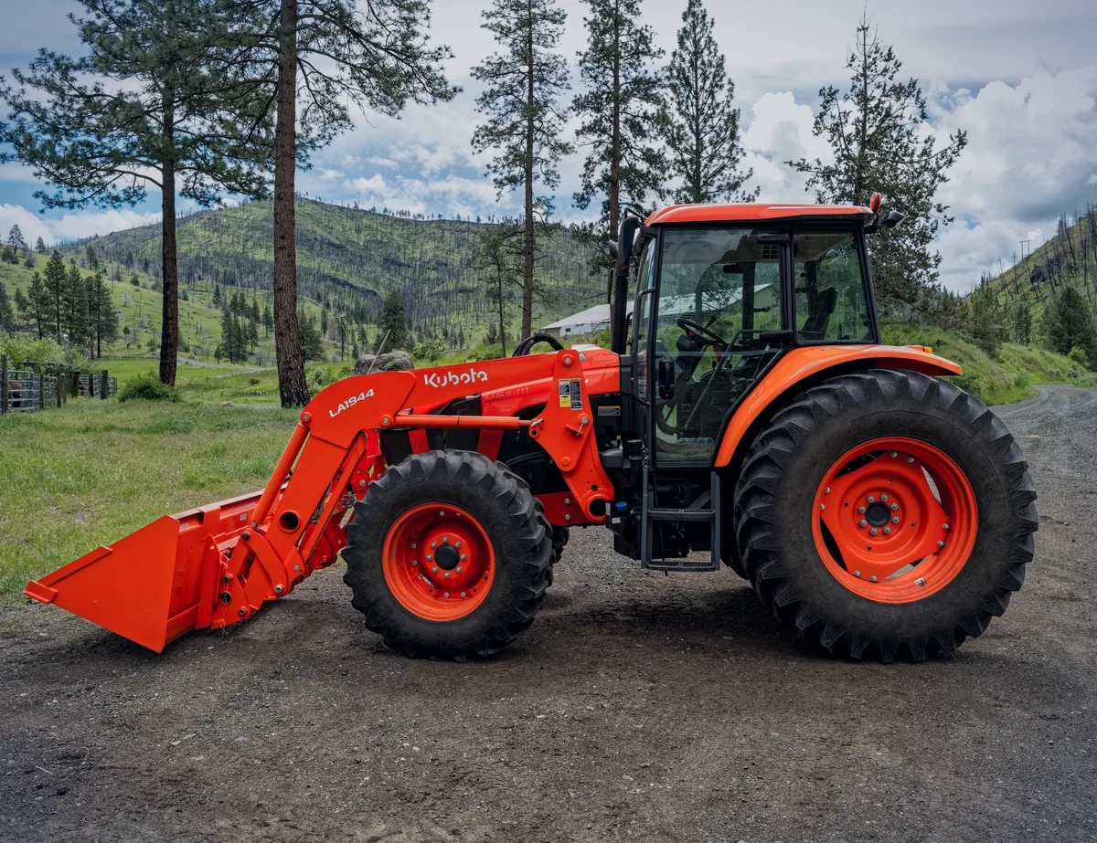 Kubota tractor with a front loader parked on a ranch road