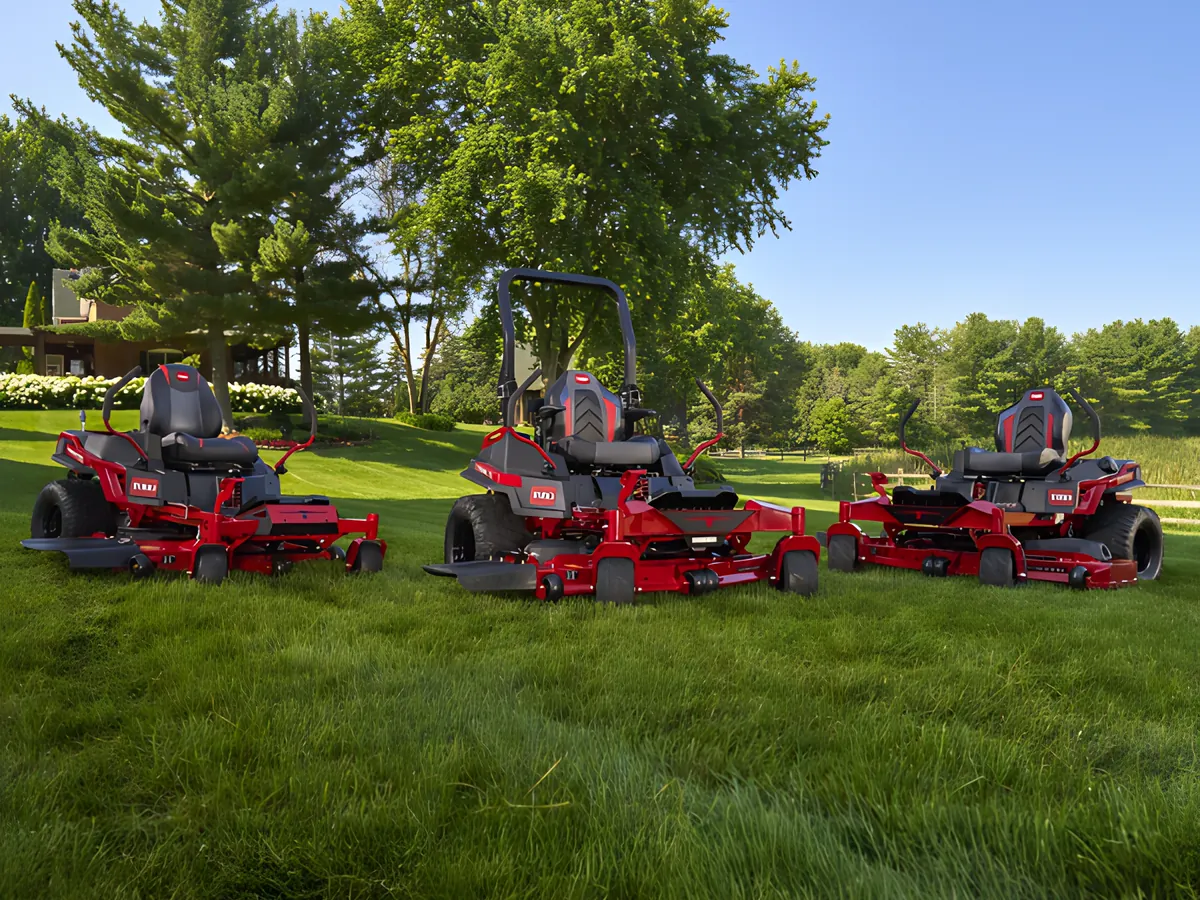 Three Toro zero-turn mowers parked on a freshly mowed lawn