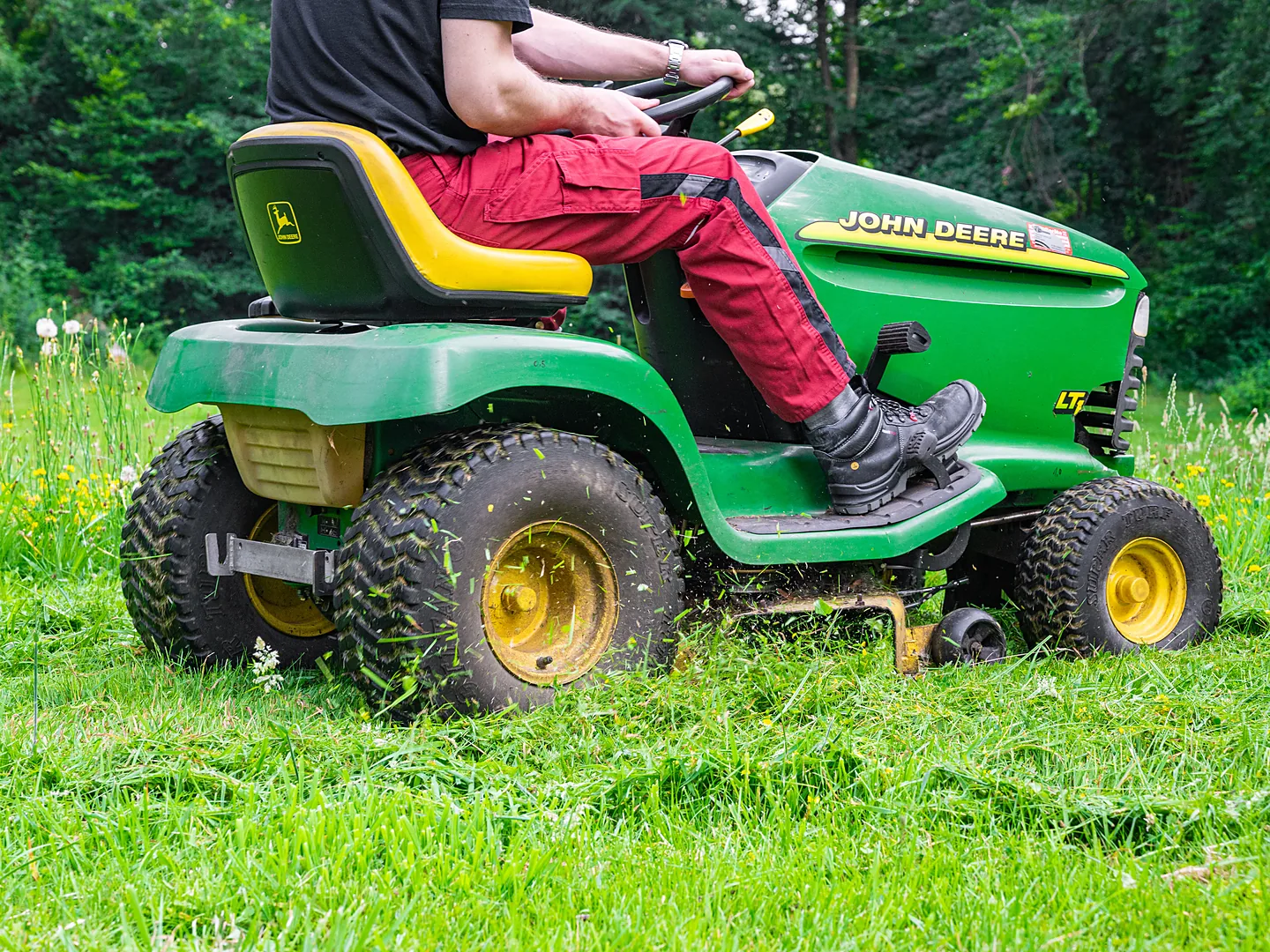 Operator on a John Deere riding mower