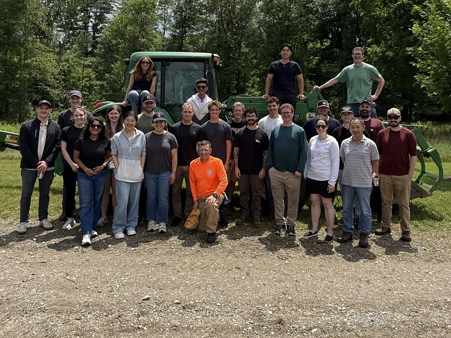 The Flyntlok team standing in front of a tractor