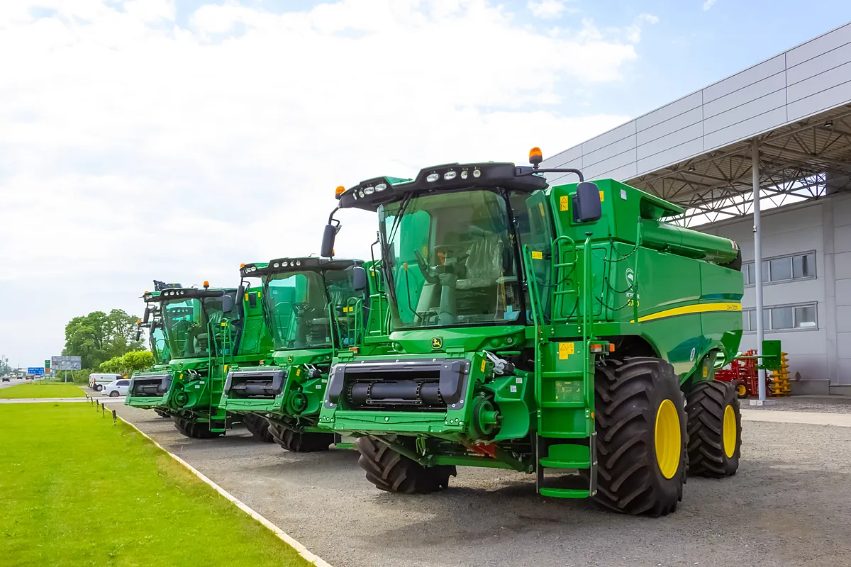 John Deere combines on a dealership lot