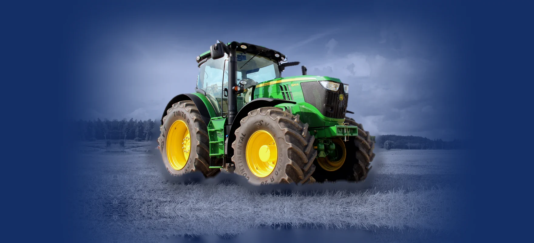 John Deere 6210R tractor parked on a harvested field