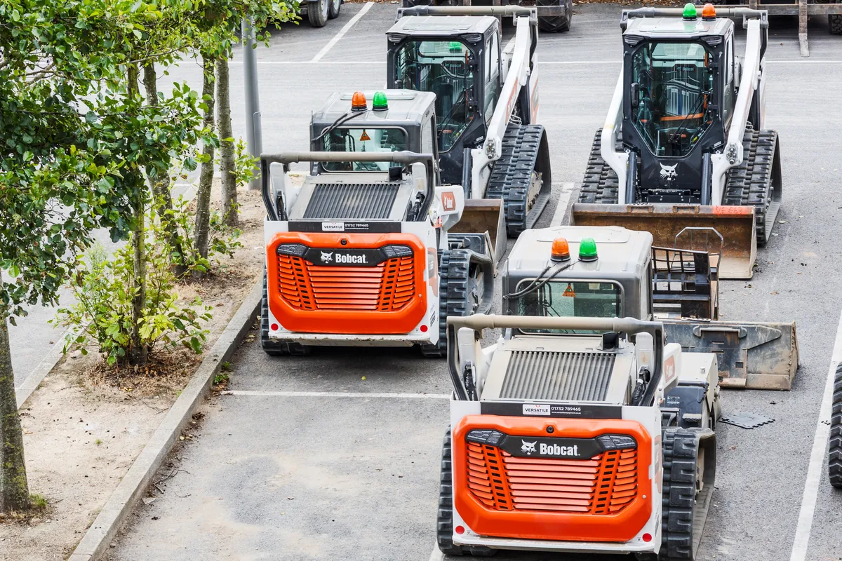 Row of Bobcat compact track loaders parked at an equipment yard