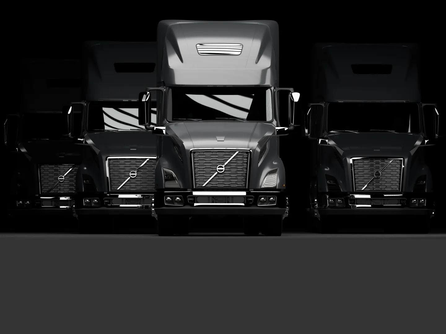 Row of black Volvo VNL trucks