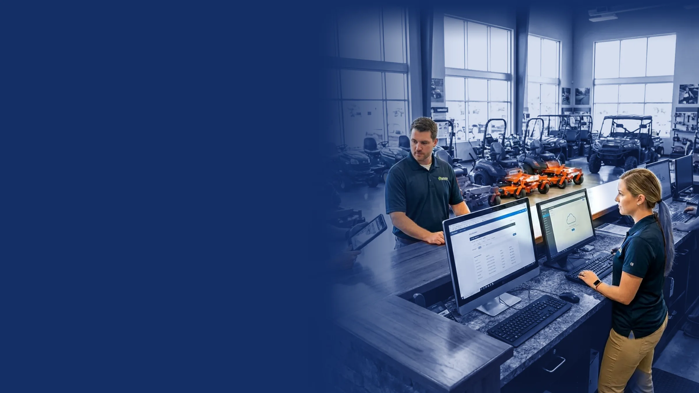 Dealership counter team working at computers in an equipment showroom