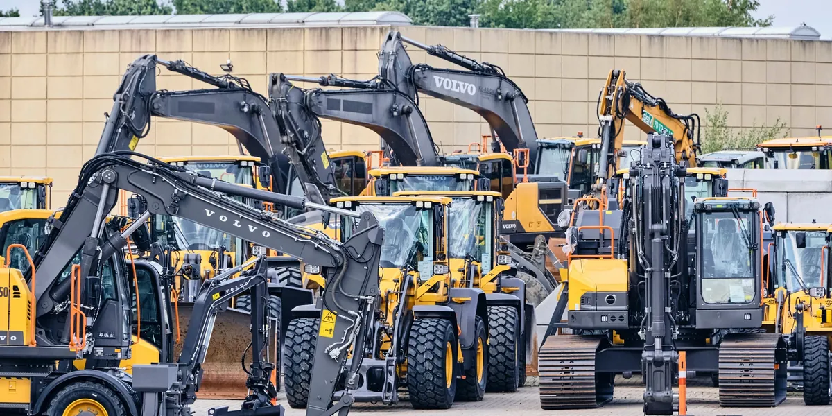 New Volvo excavators and wheel loaders lined up on a dealer lot