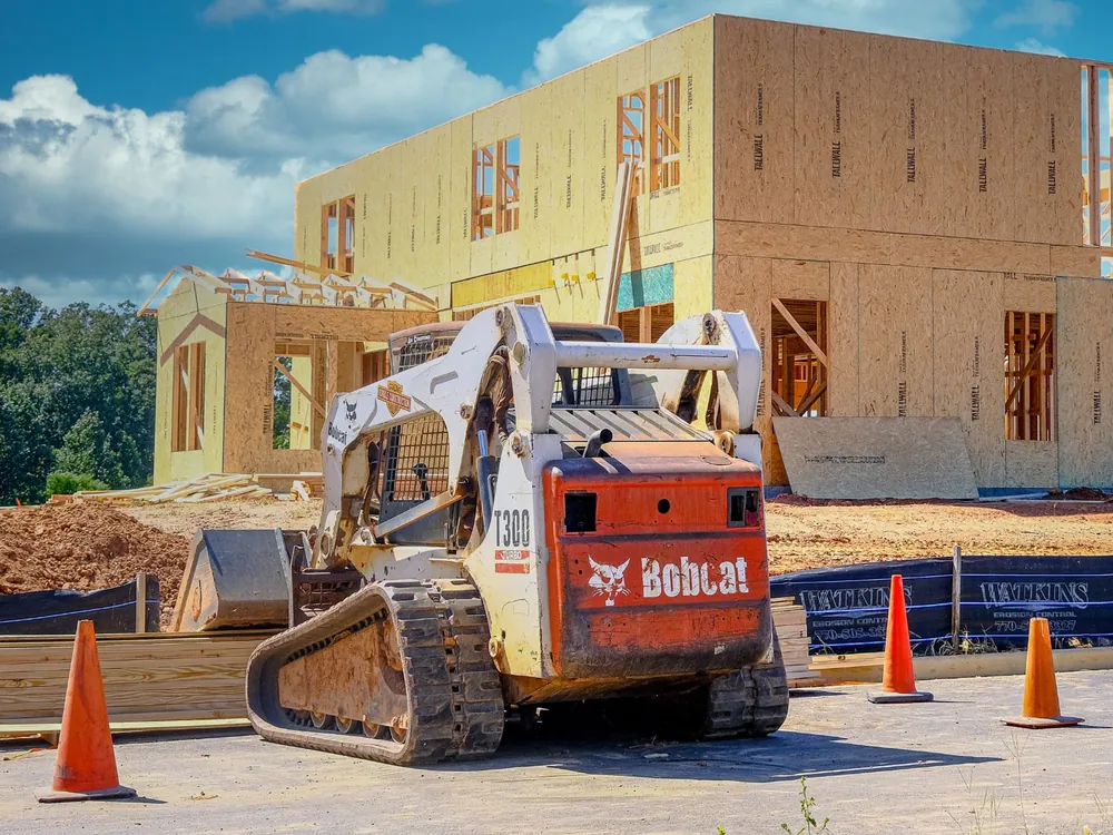 Bobcat compact track loader at a home building site