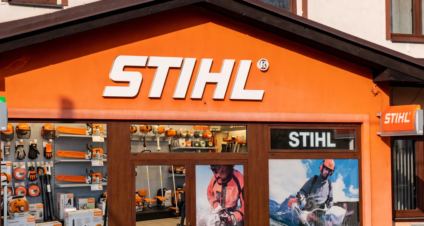 STIHL dealer storefront with chainsaws, trimmers, and helmets on the wall