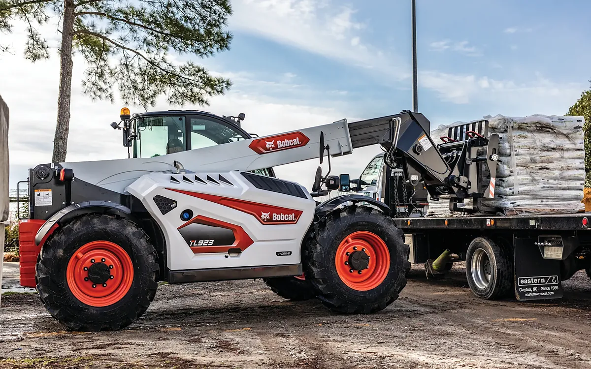 Bobcat TL923 telehandler loading a pallet onto a flatbed truck