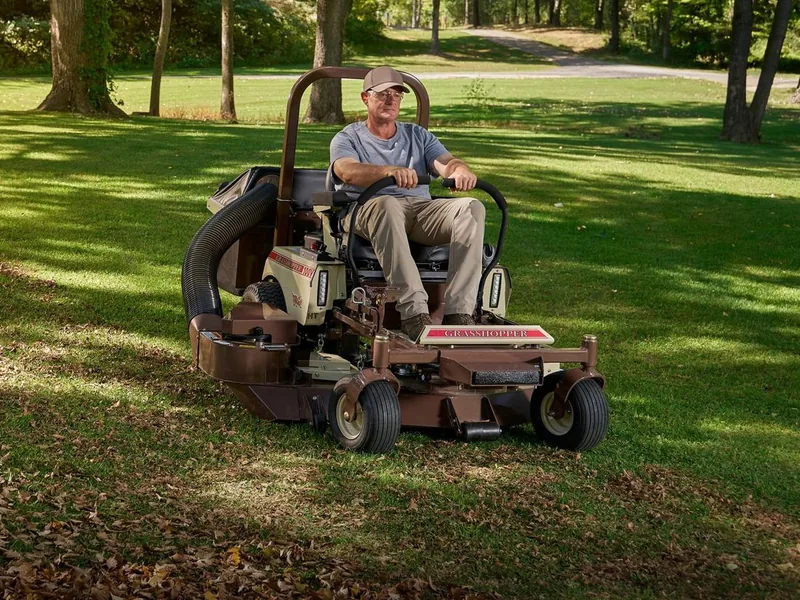Operator mowing leaves on a Grasshopper zero-turn mower