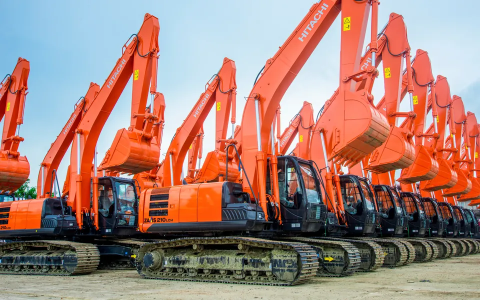 Row of new Hitachi excavators on a dealer lot