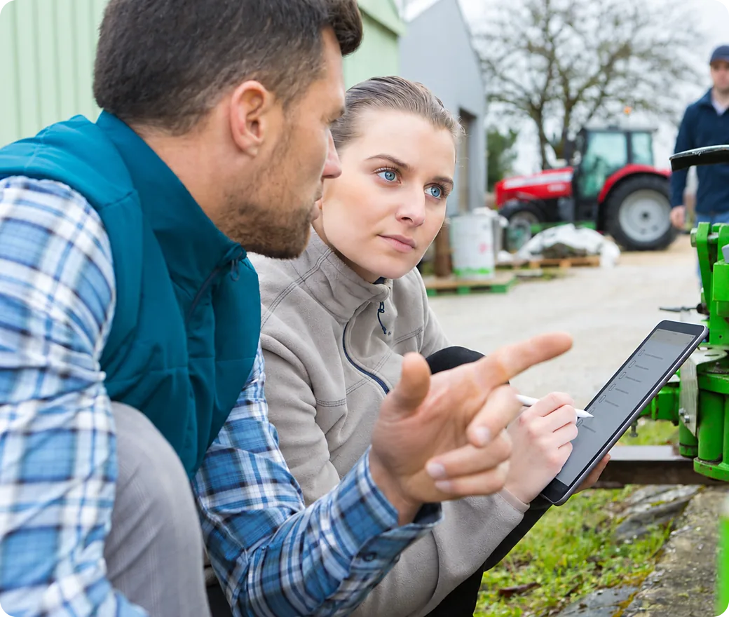 Technician and customer review a returned machine's condition on a tablet