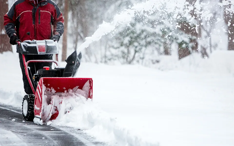 Snow blower clearing a path after a storm