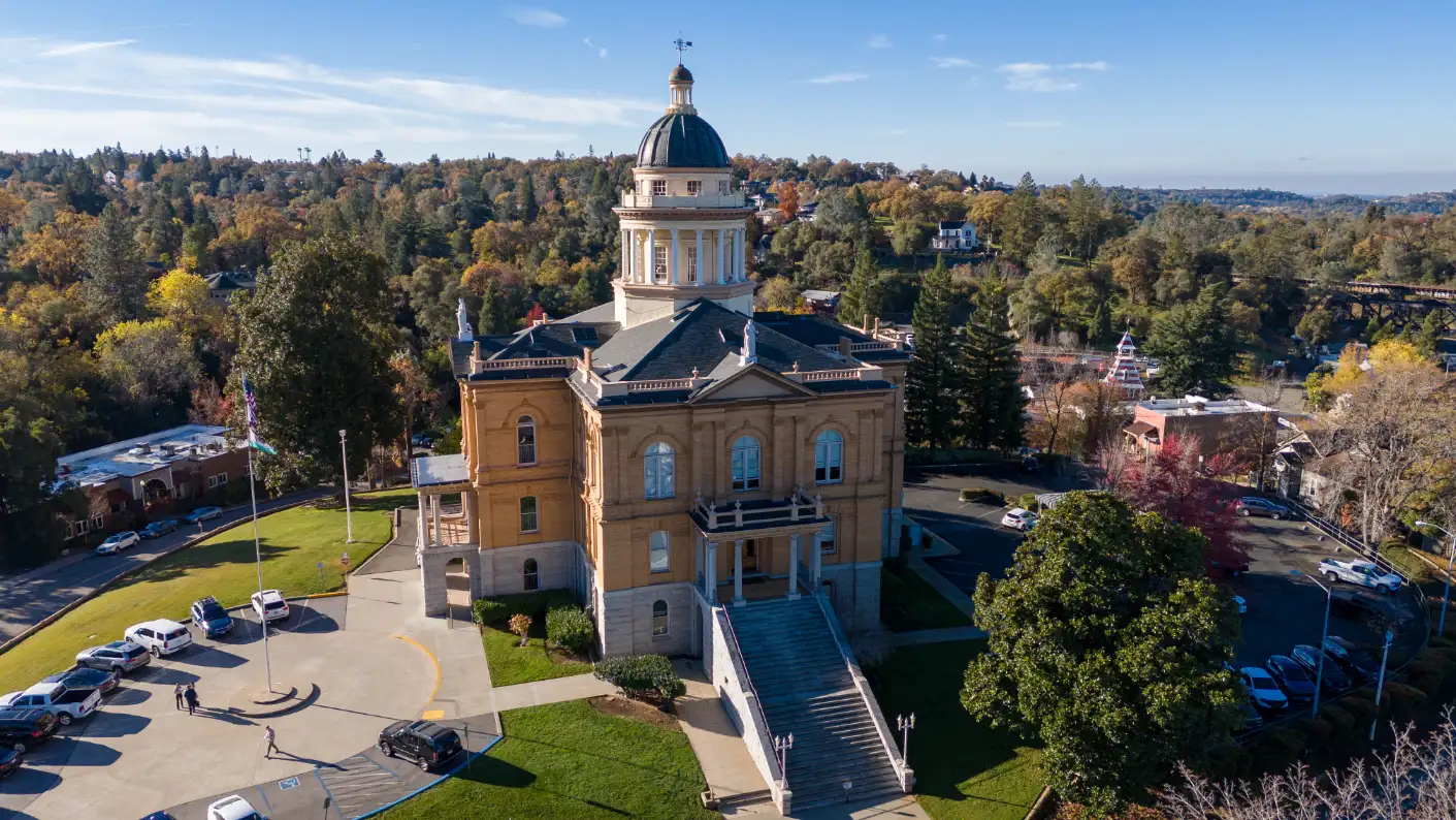 Auburn CA historic courthouse with distinctive architecture surrounded by vibrant fall foliage.