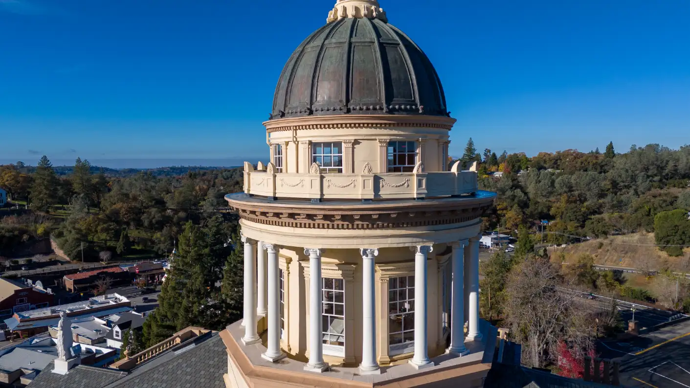 Dome of the historic Placer County Courthouse in Auburn, CA, against a clear blue sky.