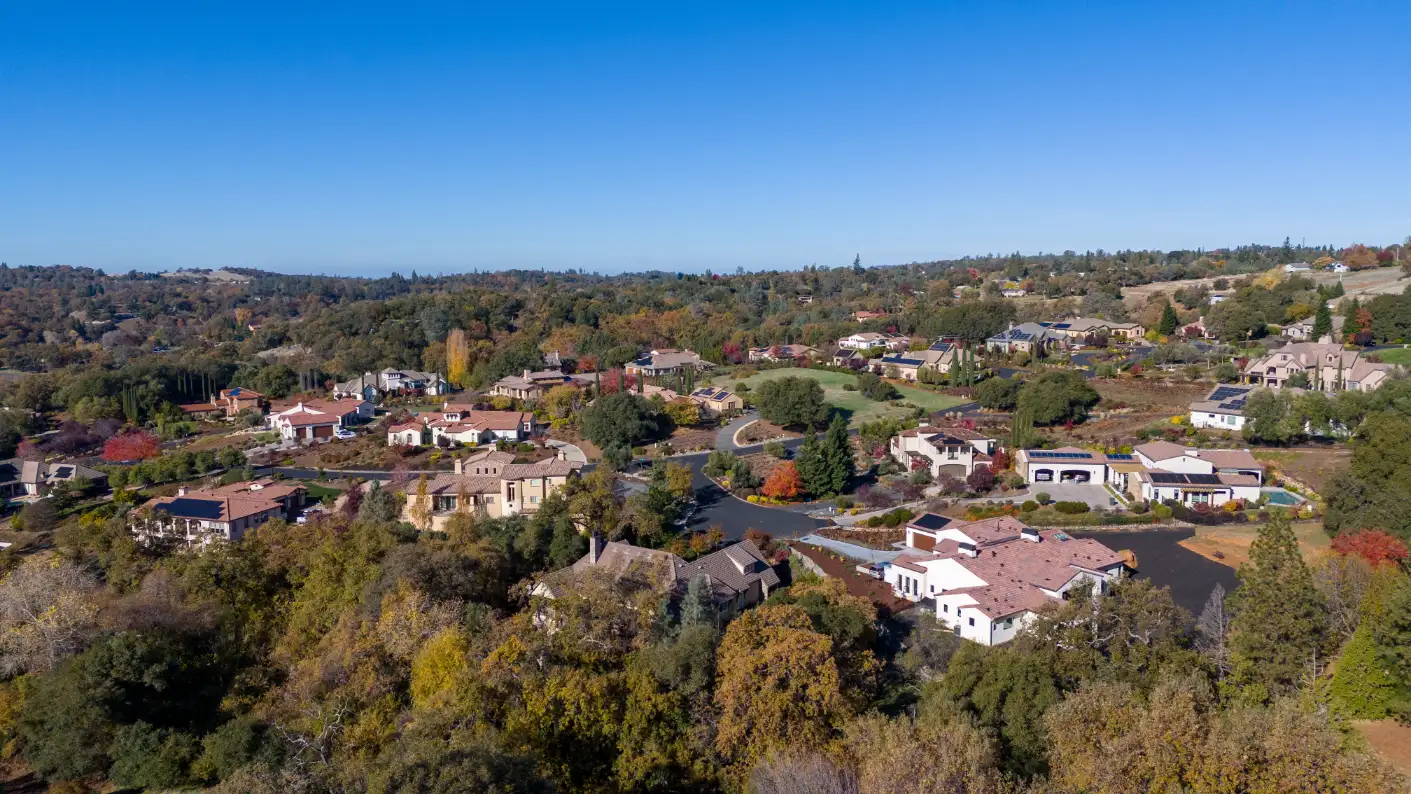 Scenic aerial view of a residential neighborhood with diverse housing in Auburn, CA.