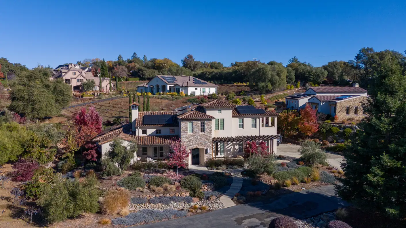 Luxury houses in an affluent neighborhood surrounded by autumn foliage in Auburn, CA.