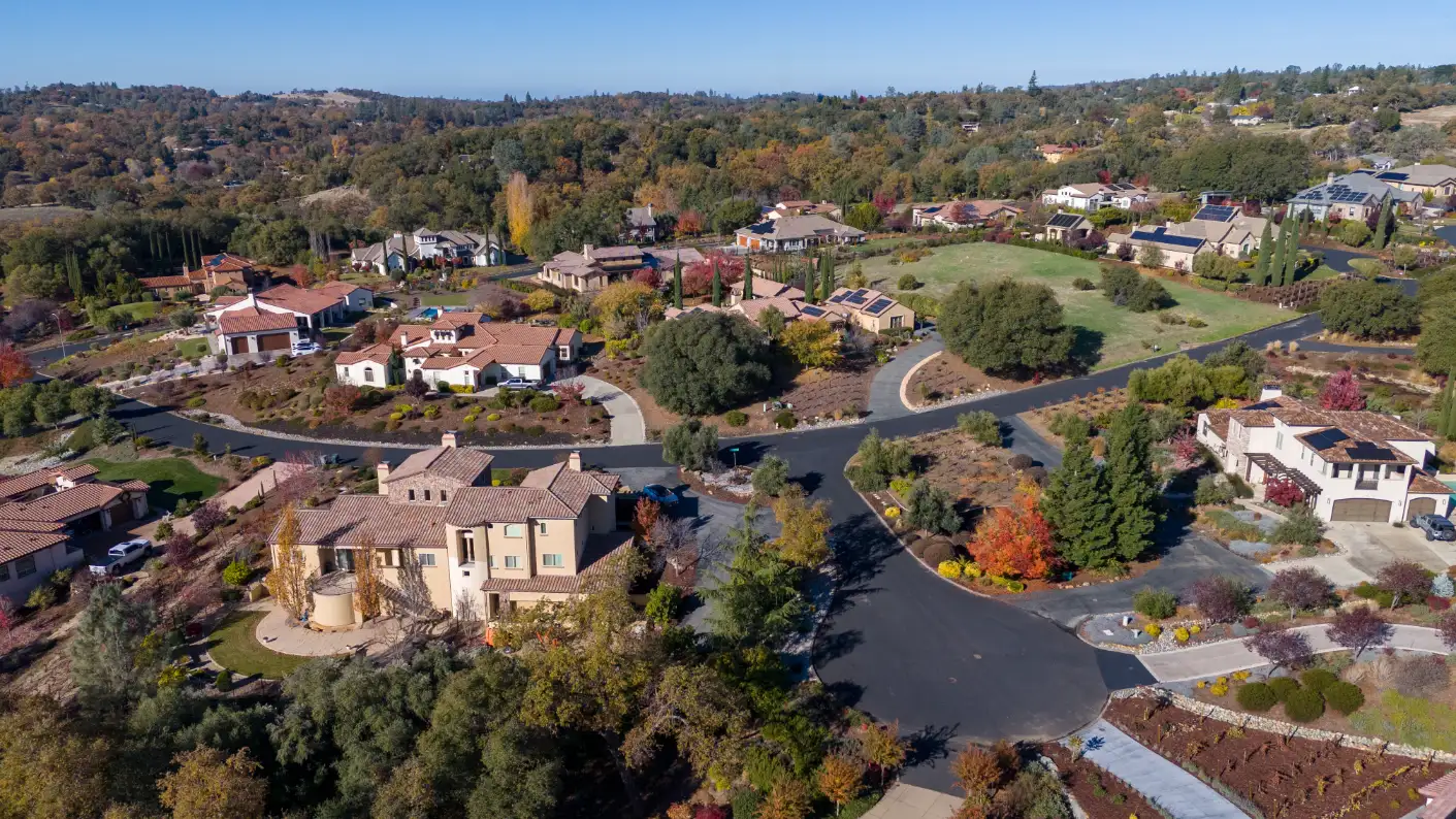 Auburn CA real estate with sprawling houses and mature trees in a serene suburban setting