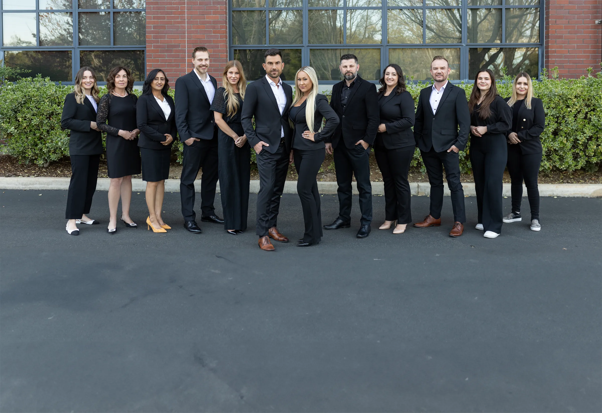a group of business people posing for a picture - eastok realty team