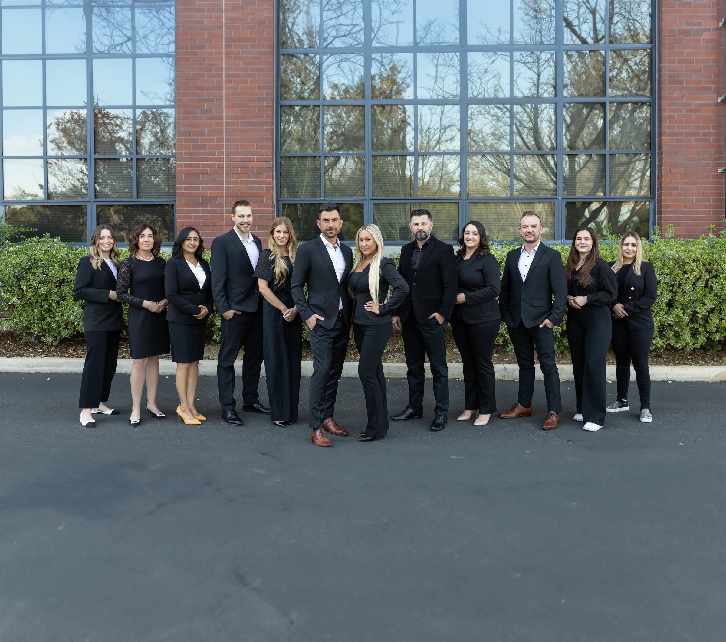 a group of business people posing for a picture - eastok realty team